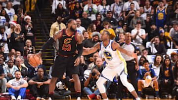 OAKLAND, CA - DECEMBER 25: LeBron James #23 of the Cleveland Cavaliers handles the ball against Andre Iguodala #9 of the Golden State Warriors on December 25, 2017 at ORACLE Arena in Oakland, California. NOTE TO USER: User expressly acknowledges and agrees that, by downloading and or using this photograph, user is consenting to the terms and conditions of Getty Images License Agreement. Mandatory Copyright Notice: Copyright 2017 NBAE (Photo by Noah Graham/NBAE via Getty Images)
