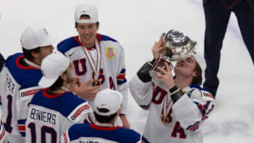 EDMONTON, AB - JANUARY 05: Cole Caulfield #13 of the United States with the World Juniors trophy after defeating Canada during the 2021 IIHF World Junior Championship gold medal game at Rogers Place on January 5, 2021 in Edmonton, Canada. (Photo by Codie McLachlan/Getty Images)