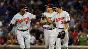 Sep 14, 2016; Boston, MA, USA; Baltimore Orioles starting pitcher Kevin Gausman (39) congratulates second baseman Jonathan Schoop (6) after he made a catch while colliding with first baseman Chris Davis (19) during the eighth inning against the Boston Red Sox at Fenway Park. Mandatory Credit: Winslow Townson-USA TODAY Sports