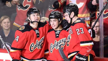Dec 22, 2015; Calgary, Alberta, CAN; Calgary Flames left wing Johnny Gaudreau (13) celebrates his second goal of the night with center Jiri Hudler (24) and center Sean Monahan (23) against the Winnipeg Jets at Scotiabank Saddledome. Flames won 4-1. Mandatory Credit: Candice Ward-USA TODAY Sports