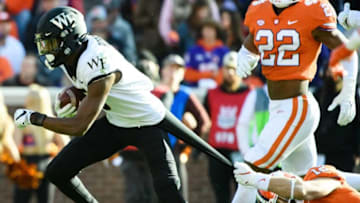 Nov 20, 2021; Clemson, South Carolina, USA; Wake Forest receiver Jaquarii Roberson (5) attempts to evade Clemson safety Tyler Venables (12) during their game at Memorial Stadium. Mandatory Credit: Josh Morgan-USA TODAY Sports