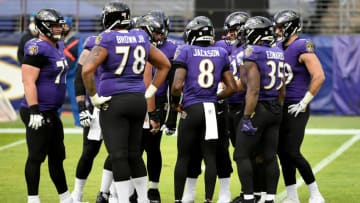 BALTIMORE, MARYLAND - DECEMBER 20: Quarterback Lamar Jackson #8 of the Baltimore Ravens calls a play in the huddle during the second half against the Jacksonville Jaguars at M&T Bank Stadium on December 20, 2020 in Baltimore, Maryland. (Photo by Will Newton/Getty Images)