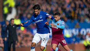 LIVERPOOL, ENGLAND - OCTOBER 19: Andre Gomes of Everton and Manuel Lanzini of West Ham United in action during the Premier League match between Everton FC and West Ham United at Goodison Park on October 19, 2019 in Liverpool, United Kingdom. (Photo by Visionhaus)