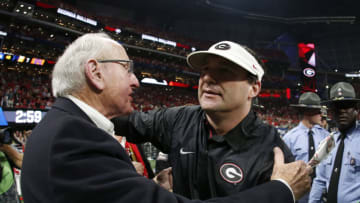 Dec 2, 2017; Atlanta, GA, USA; Georgia Bulldogs head coach Kirby Smart hugs Vince Dooley after defeating the Auburn Tigers in the SEC Championship game at Mercedes-Benz Stadium. Mandatory Credit: Brett Davis-USA TODAY Sports
