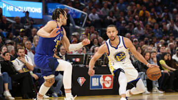 Stephen Curry #30 of the Golden State Warriors is guarded by Aaron Gordon #50 of the Denver Nuggets in the second half during Game Two of the Western Conference First Round NBA Playoffs at Chase Center on 18 Apr. 2022 in San Francisco, California. (Photo by Ezra Shaw/Getty Images)