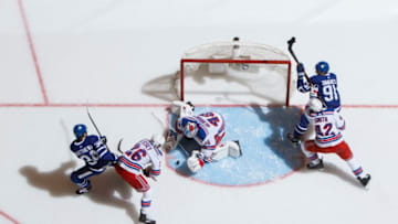 TORONTO, ON - MARCH 23: Alexandar Georgiev #40 of the New York Rangers makes a save as Jimmy Vesey #26 battles against Auston Matthews #34 of the Toronto Maple Leafs during the third period at the Scotiabank Arena on March 23, 2019 in Toronto, Ontario, Canada. (Photo by Mark Blinch/NHLI via Getty Images)