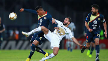 MEXICO CITY, MEXICO - DECEMBER 06: Roger Martinez #9 of America struggles for the ball with Luis Quintana #4 of Pumas during the semifinal first leg match between Pumas UNAM and America as part of the Torneo Apertura 2018 Liga MX at Olimpico Universitario Stadium on December 6, 2018 in Mexico City, Mexico. (Photo by Hector Vivas/Getty Images)