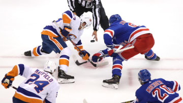 TORONTO, ONTARIO - JULY 29: Casey Cizikas #53 of the New York Islanders and Mika Zibanejad #93 of the New York Rangers take the face off in the third period during an exhibition game prior to the 2020 NHL Stanley Cup Playoffs at Scotiabank Arena on July 29, 2020 in Toronto, Ontario. (Photo by Andre Ringuette/Freestyle Photo/Getty Images)