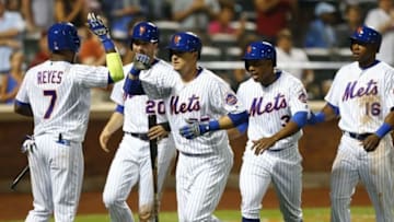 Aug 27, 2016; New York City, NY, USA; New York Mets Jose Reyes (7) greets Kelly Johnson (55) after his grand slam in the seventh inning scoring New York Mets Neil Walker (20), right fielder Curtis Granderson (3) and center fielder Alejandro De Aza (16) in the seventh inning against the Philadelphia Phillies at Citi Field. Mandatory Credit: Noah K. Murray-USA TODAY Sports