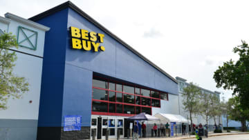 Customers wearing face masks wait in line to enter a Best Buy electronic store on July 16, 2020 in Pembroke Pines, Florida. (Photo by Johnny Louis/Getty Images)