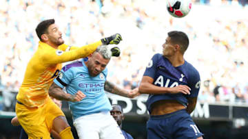 MANCHESTER, ENGLAND - AUGUST 17: Hugo Lloris of Tottenham Hotspur punches the ball away and collides with Nicolas Otamendi of Manchester City during the Premier League match between Manchester City and Tottenham Hotspur at Etihad Stadium on August 17, 2019 in Manchester, United Kingdom. (Photo by Clive Brunskill/Getty Images)