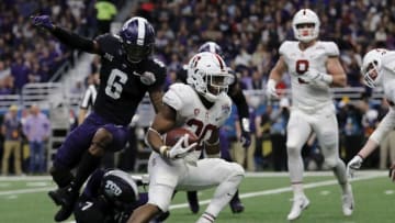 SAN ANTONIO, TX - DECEMBER 28: Bryce Love #20 of the Stanford Cardinal runs past Innis Gaines #6 of the TCU Horned Frogs and Arico Evans #7 in the second quarter during the Valero Alamo Bowl at the Alamodome on December 28, 2017 in San Antonio, Texas. (Photo by Tim Warner/Getty Images)