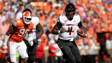 CLEMSON, SC - NOVEMBER 03: Jawon Pass #4 of the Louisville Cardinals tries to get away from Clelin Ferrell #99 of the Clemson Tigers during their game at Clemson Memorial Stadium on November 3, 2018 in Clemson, South Carolina. (Photo by Streeter Lecka/Getty Images)