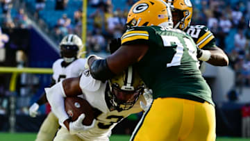 Sep 12, 2021; Jacksonville, Florida, USA; Green Bay Packers guard Elgton Jenkins (74) tackles New Orleans Saints safety Marcus Williams (43) along the sideline during the third quarter at TIAA Bank Field. Mandatory Credit: Tommy Gilligan-USA TODAY Sports