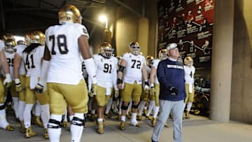 November 28, 2015; Stanford, CA, USA; Notre Dame Fighting Irish head coach Brian Kelly (right) leads the players out onto the field to play against Stanford Cardinal during at Stanford Stadium. Mandatory Credit: Gary A. Vasquez-USA TODAY Sports