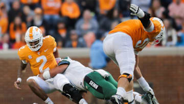 KNOXVILLE, TN - NOVEMBER 3: Alex Highsmith #5 of the Charlotte 49ers gets by Offensive lineman Nathan Niehaus #57 of the Tennessee Volunteers and causes a sack-fumble as he hits Quarterback Jarrett Guarantano #2 of the Tennessee Volunteers during the game between the Charlotte 49ers and the Tennessee Volunteers at Neyland Stadium on November 3, 2018 in Knoxville, Tennessee. Tennessee won the game 14-3. (Photo by Donald Page/Getty Images)