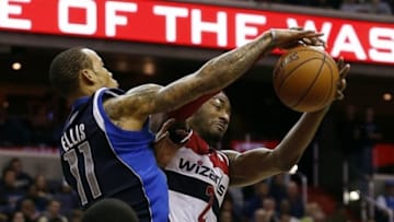 Jan 1, 2014; Washington, DC, USA; Dallas Mavericks shooting guard Monta Ellis (11) and Washington Wizards point guard John Wall (2) battle for the ball in the fourth quarter at Verizon Center. The Mavericks won 87-78. Mandatory Credit: Geoff Burke-USA TODAY Sports