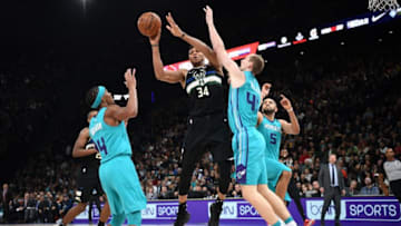Milwaukee Bucks forward Giannis Antetokounmpo (C) passes the ball past Charlotte Hornets forward-centre Cody Zeller (R) and Charlotte Hornets guard Devonte' Graham (L) during the NBA basketball match between Milwaukee Bucks and Charlotte Hornets at The AccorHotels Arena in Paris on January 24, 2020. (Photo by FRANCK FIFE / AFP) (Photo by FRANCK FIFE/AFP via Getty Images)