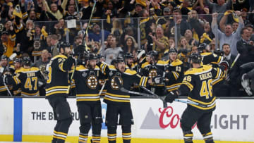 BOSTON, MA - MAY 27: From left, Bruins Zdeno Chara, Patrice Bergeron, Brad Marchand and David Krejci celebrate, as does the players on the bench in the background as well as the crowd following Marchand's empty net goal that wrapped up Boston's victory. The Boston Bruins host the St. Louis Blues in Game One of the 2019 Stanley Cup Finals at TD Garden on May 27, 2019. (Photo by Jim Davis/The Boston Globe via Getty Images)