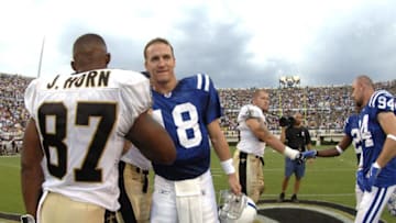 Indianapolis Colts quarterback Peyton Manning greets New Orleans Saints wide receiver Joe Horn before the coin toss at Veterans Memorial Stadium in Jackson, Mississippi on August 26, 2006. The Colts won 27-14. (Photo by A. Messerschmidt/Getty Images)