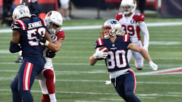 Nov 29, 2020; Foxborough, Massachusetts, USA; New England Patriots wide receiver Gunner Olszewski (80) runs the ball while linebacker Anfernee Jennings (58) is flagged for an illegal block during the second half against the Arizona Cardinals at Gillette Stadium. Mandatory Credit: Bob DeChiara-USA TODAY Sports