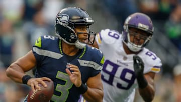 SEATTLE, WA - AUGUST 18: Quarterback Russell Wilson #3 of the Seattle Seahawks scrambles under pressure from defensive end Danielle Hunter #99 of the Minnesota Vikings at CenturyLink Field on August 18, 2017 in Seattle, Washington. (Photo by Otto Greule Jr/Getty Images)