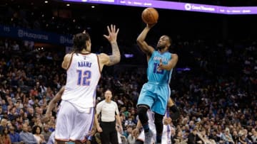Jan 2, 2016; Charlotte, NC, USA; Charlotte Hornets guard Kemba Walker (15) goes up for a shot against Oklahoma City Thunder center Steven Adams (12) during the second half at Time Warner Cable Arena. The Thunder defeated the Hornets 109-90. Mandatory Credit: Jeremy Brevard-USA TODAY Sports
