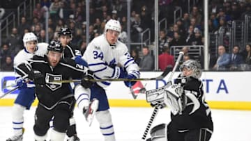 Auston Matthews #34 of the Toronto Maple Leafs attempts a deflection on Jonathan Quick #32 of the Los Angeles Kings as Alec Martinez #27 defends. (Photo by Harry How/Getty Images)