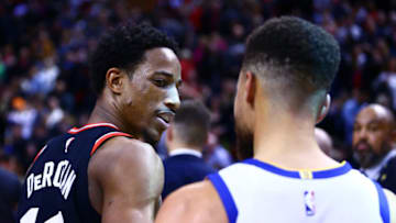 TORONTO, ON - JANUARY 13: DeMar DeRozan #10 of the Toronto Raptors talks with Stephen Curry #30 of the Golden State Warriors following the final whistle of an NBA game at Air Canada Centre on January 13, 2018 in Toronto, Canada. NOTE TO USER: User expressly acknowledges and agrees that, by downloading and or using this photograph, User is consenting to the terms and conditions of the Getty Images License Agreement. (Photo by Vaughn Ridley/Getty Images)