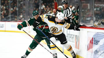 Apr 4, 2019; Saint Paul, MN, USA; Boston Bruins center Trent Frederic (82) protects the puck against the Minnesota Wild center Joel Eriksson Ek (14) in the first period at Xcel Energy Center. Mandatory Credit: David Berding-USA TODAY Sports