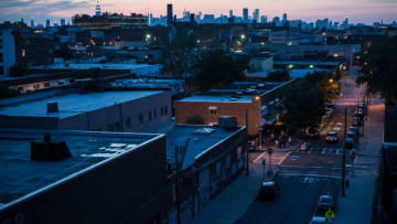 NEW YORK, NY - JUNE 15: The New York skyline is seen at sunset while camping on an undisclosed rooftop on June 15, 2013 in the Brooklyn Borough of New York City. The project, arranged by artist Thomas Stevenson, is called "Bivouac New York," and sets up campsites for guests at various rooftops throughout the summer. Campers are encouraged to turn off their electronic gadgets while focusing on exploring outdoor environments within a city context and engaging in conversations with other campers. (Photo by Andrew Burton/Getty Images)