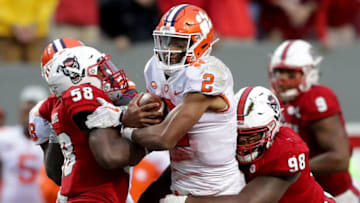 RALEIGH, NC - NOVEMBER 04: Teammates Airius Moore #58 and B.J. Hill #98 of the North Carolina State Wolfpack tackle Kelly Bryant #2 of the Clemson Tigers during their game at Carter Finley Stadium on November 4, 2017 in Raleigh, North Carolina. (Photo by Streeter Lecka/Getty Images)