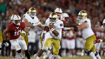 PALO ALTO, CA - NOVEMBER 25: Brandon Wimbush #7 of the Notre Dame Fighting Irish scrambles with the ball against the Stanford Cardinal at Stanford Stadium on November 25, 2017 in Palo Alto, California. (Photo by Ezra Shaw/Getty Images)