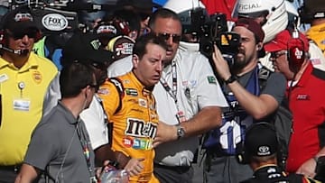 LAS VEGAS, NV - MARCH 12: Kyle Busch, driver of the #18 M&M's Toyota, is escorted away by a NASCAR official after an incident on pit road with Joey Logano (not pictured), driver of the #22 Pennzoil Ford, following the Monster Energy NASCAR Cup Series Kobalt 400 at Las Vegas Motor Speedway on March 12, 2017 in Las Vegas, Nevada. Busch and Logano made contact on the track during the last lap of the race leading to the incident on pit road. (Photo by Chris Graythen/Getty Images)