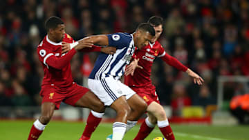 LIVERPOOL, ENGLAND - DECEMBER 13: Jose Salomon Rondon of West Bromwich Albion is challenged by Georginio Wijnaldum of Liverpool and Andy Robertson of Liverpool during the Premier League match between Liverpool and West Bromwich Albion at Anfield on December 13, 2017 in Liverpool, England. (Photo by Clive Brunskill/Getty Images)