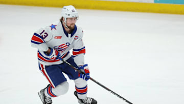 SYRACUSE, NY - APRIL 22: Linus Weissbach #13 of Rochester Americans moves the puck against the Rochester Americans during Game 2 of the north division semifinals of the Calder Cup Playoffs at Upstate Medical University Arena on April 22, 2023 in Syracuse, New York. (Photo by Isaiah Vazquez/Getty Images)