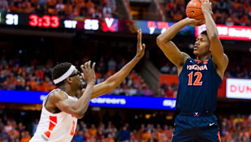 SYRACUSE, NY - MARCH 04: De'Andre Hunter #12 of the Virginia Cavaliers shoots the ball during the first half as he is fouled by Paschal Chukwu #13 of the Syracuse Orange at the Carrier Dome on March 4, 2019 in Syracuse, New York. (Photo by Brett Carlsen/Getty Images)