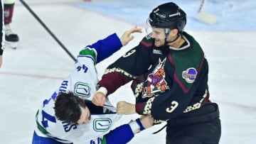 Apr 13, 2023; Tempe, Arizona, USA; Arizona Coyotes defenseman Josh Brown (3) and Vancouver Canucks defenseman Kyle Burroughs (44) fight oin the third period at Mullett Arena. Mandatory Credit: Matt Kartozian-USA TODAY Sports
