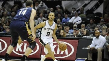 Nov 25, 2013; San Antonio, TX, USA; San Antonio Spurs guard Tony Parker (9) drives against New Orleans Pelicans center Jason Smith (14) during the first quarter at the AT