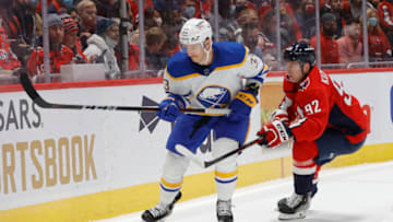 Nov 8, 2021; Washington, District of Columbia, USA; Buffalo Sabres defenseman Colin Miller (33) skates with the puck as Washington Capitals center Evgeny Kuznetsov (92) chases during the first period at Capital One Arena. Mandatory Credit: Geoff Burke-USA TODAY Sports