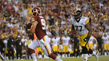 LANDOVER - AUGUST 19: Washington Redskins linebacker Ryan Kerrigan (91) intercepts a pass by Pittsburgh Steelers quarterback Ben Roethlisberger (7) which he ran in for a touchdown, giving the Redskins a 7-0 advantage in the first quarter during the game between the Washington Redskins and the Pittsburgh Steelers at FedEx Field on Monday, August 19, 2013. (Photo by Toni L. Sandys/The Washington Post via Getty Images)