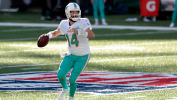 Nov 29, 2020; East Rutherford, New Jersey, USA; Miami Dolphins quarterback Ryan Fitzpatrick (14) moves out to pass against the New York Jets during the first half at MetLife Stadium. Mandatory Credit: Vincent Carchietta-USA TODAY Sports