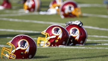 Jun 17, 2014; Ashburn, VA, USA; Washington Redskins helmets rest on the field during minicamp at Redskins Park. Mandatory Credit: Geoff Burke-USA TODAY Sports