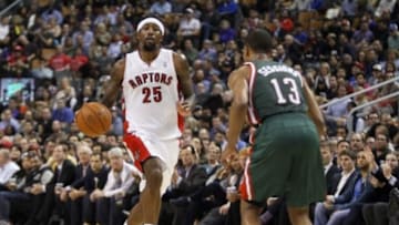 Apr 14, 2014; Toronto, Ontario, CAN; Toronto Raptors guard-forward John Salmons (25) carries the ball as Milwaukee Bucks guard Ramon Sessions (13) defends during the first half at the Air Canada Centre. Mandatory Credit: John E. Sokolowski-USA TODAY Sports