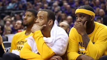 Apr 18, 2016; Toronto, Ontario, CAN; Indiana Pacers forward Paul George (13) and point guard Monta Ellis (11) and guard Ty Lawson (10) look on from the bench in the closing moments of the game against the Toronto Raptors in game two of the first round of the 2016 NBA Playoffs at Air Canada Centre. The Raptors beat the Pacers 98-87. Mandatory Credit: Tom Szczerbowski-USA TODAY Sports