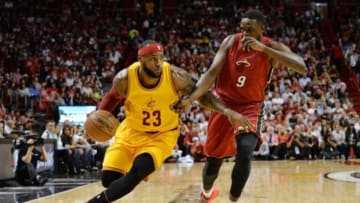 Dec 25, 2014; Miami, FL, USA; Cleveland Cavaliers forward LeBron James (23) drives to the basket around Miami Heat forward Luol Deng (9) during the first half at American Airlines Arena. Mandatory Credit: Steve Mitchell-USA TODAY Sports