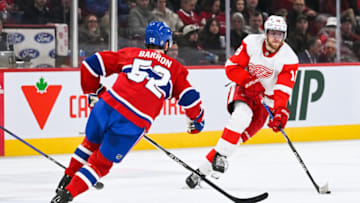 Apr 4, 2023; Montreal, Quebec, CAN; Detroit Red Wings center Andrew Copp (18) plays the puck against Montreal Canadiens defenseman Justin Barron (52) during the third period at Bell Centre. Mandatory Credit: David Kirouac-USA TODAY Sports