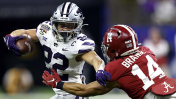 NEW ORLEANS, LOUISIANA - DECEMBER 31: Deuce Vaughn #22 of the Kansas State Wildcats is tackled by Brian Branch #14 of the Alabama Crimson Tide during the first quarter of the Allstate Sugar Bowl at Caesars Superdome on December 31, 2022 in New Orleans, Louisiana. (Photo by Sean Gardner/Getty Images)