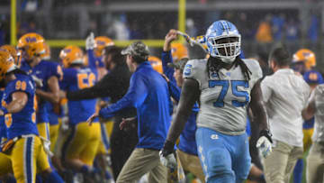 PITTSBURGH, PA - NOVEMBER 11: Joshua Ezeudu #75 of the North Carolina Tar Heels walks off the field as the Pittsburgh Panthers celebrate a 30-23 win in overtime at Heinz Field on November 11, 2021 in Pittsburgh, Pennsylvania. (Photo by Justin Berl/Getty Images)