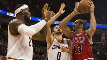 Oct 20, 2014; Columbus, OH, USA; Chicago Bulls center Joakim Noah (13) prepares to shoot over Cleveland Cavaliers forwards LeBron James (23) and Kevin Love (0) at Value City Arena. Cleveland won the game 107-98. Mandatory Credit: Greg Bartram-USA TODAY Sports